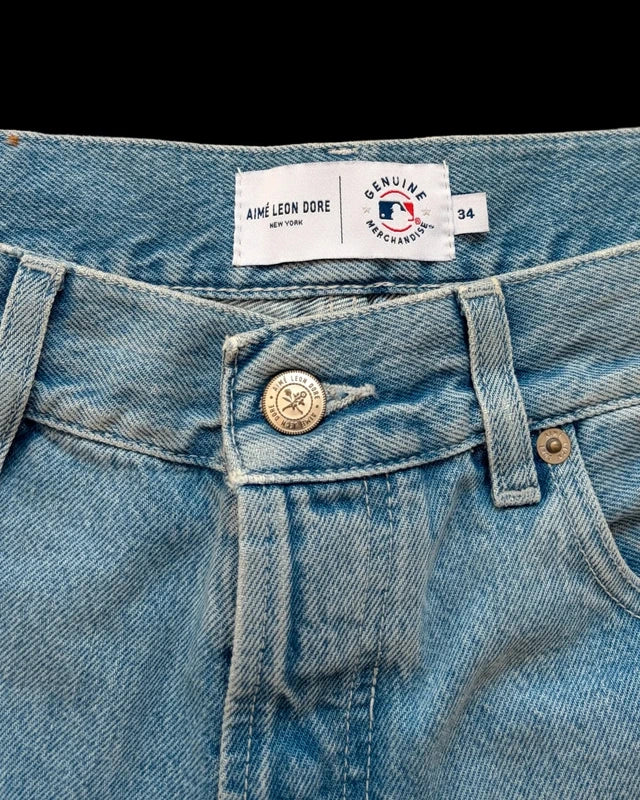 Aime Leon Dore blue denim shorts featuring New York Yankees logo and distressed details.