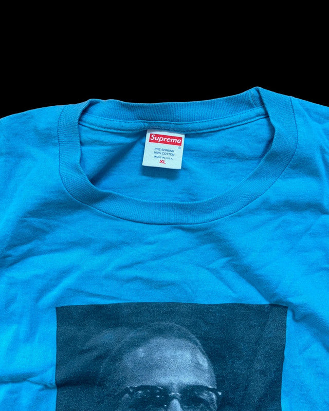 Supreme graphic tee blue featuring Malcom X print, part of Roy DeCarava collaboration.