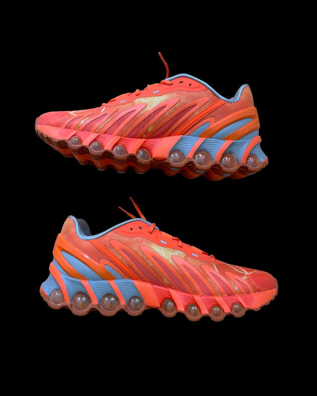 Nike Air Max Dn8 orange footwear with Palace logo and unique design details.