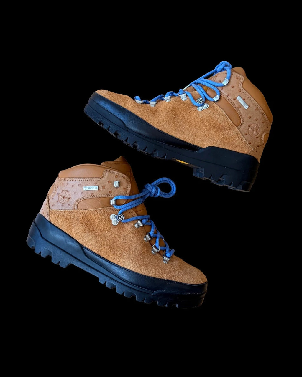 Stüssy x Timberland brown and orange hiking sandals with logo detailing and rugged sole.