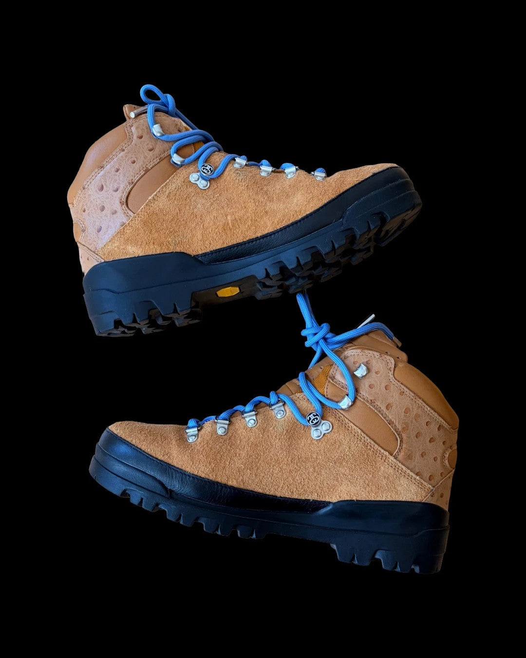 Stüssy x Timberland brown and orange hiking sandals with logo detailing and rugged sole.