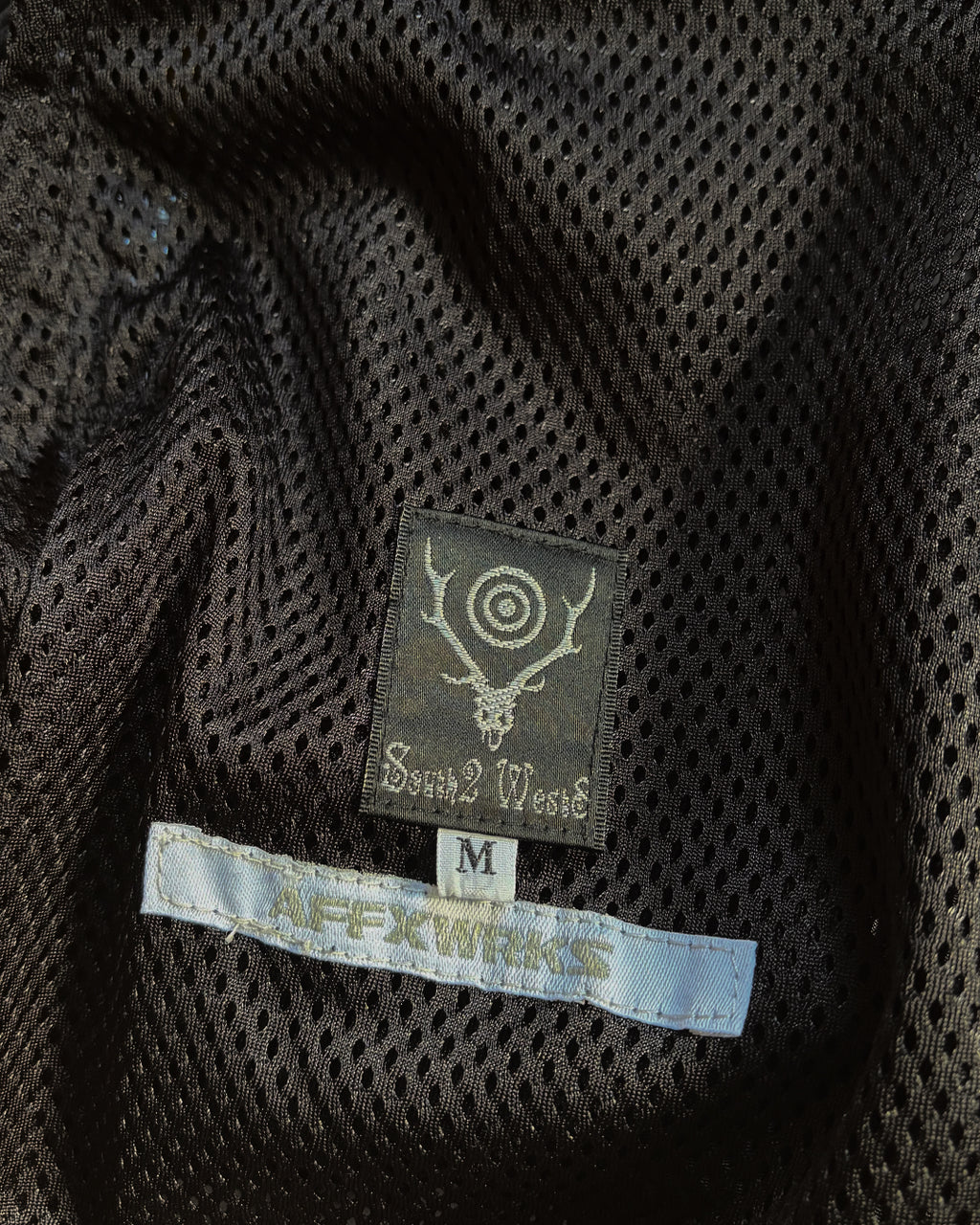 South 2 West 2 black activewear trousers, featuring logo details and premium material.